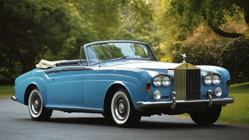 Classic blue Rolls-Royce convertible is parked on roadway