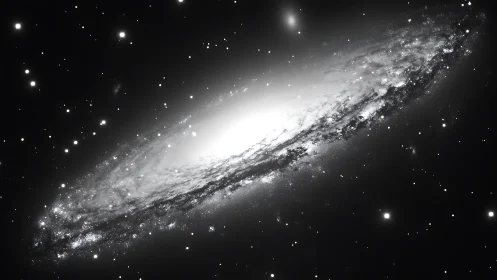Edge-on spiral galaxy glowing in dense starfield night sky.