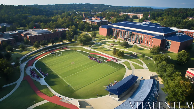 Aerial view of university sports field and campus buildings.