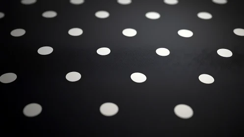 White circular dots form uniform grid on dark matte surface