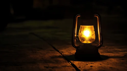 Single kerosene lantern casts localized warm illumination on floor