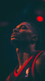 Basketball player portrait under dramatic arena lighting.