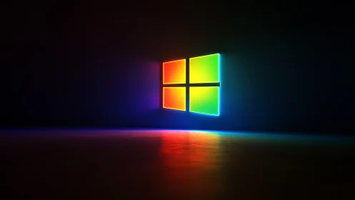 Multicolor illuminated window logo on dark reflective surface.