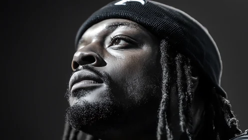 Upward gaze carves bright resolve from the shadowed quiet