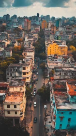 Moody vertical aerial of dense urban corridor at dusk.