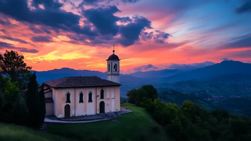 Hilltop chapel rests quietly beneath a glowing mountain sunset