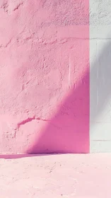 Soft pink stucco wall with vertical shadow division.