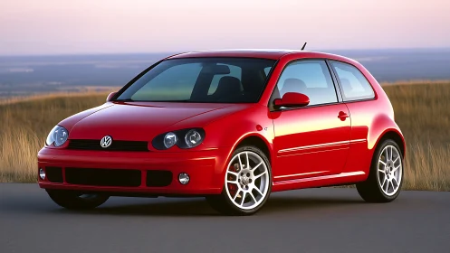 Sunset-lit red hatchback waits like a coiled weekend escape