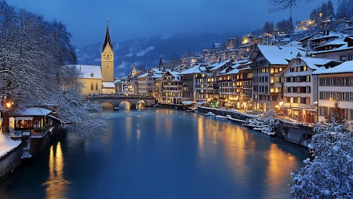 Winter riverfront town glows under deep blue twilight sky