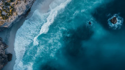 Coastal cliffs meet turquoise surf in dynamic aerial seascape