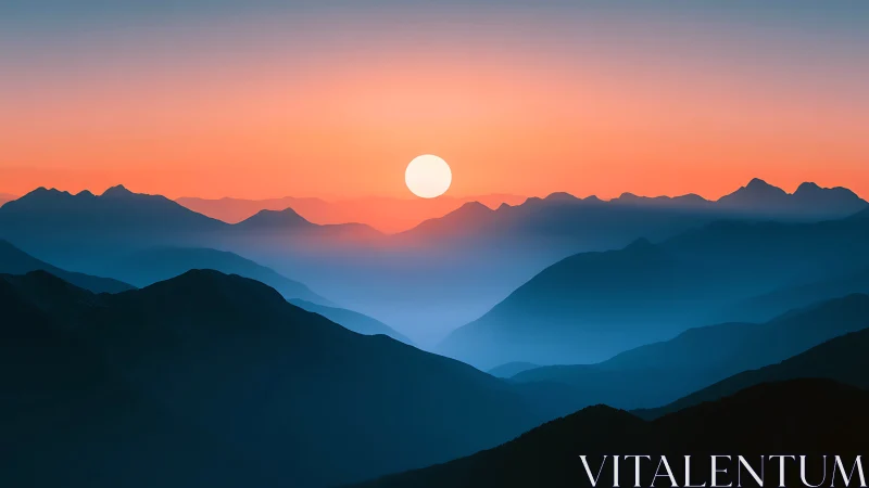 Sunset over layered blue mountains under soft orange sky.