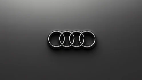 Chrome interlocking rings logo on smooth dark gradient field.