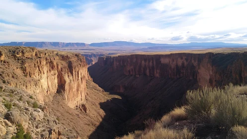 Warm desert canyon bathed in late afternoon light and shadow.