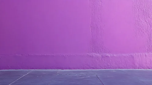 Magenta plaster wall with subtle surface variation and pavement