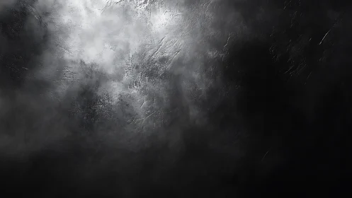 Dramatic dark textured abstract background with smoky lighting.