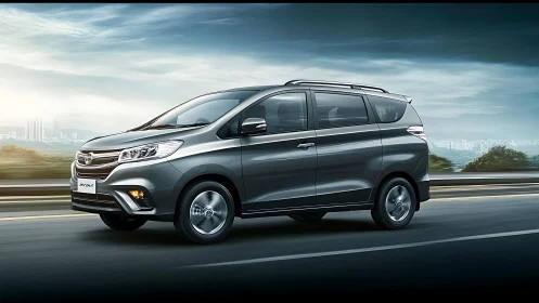 Grey multi-purpose vehicle driving on highway at speed.