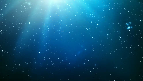 Blue star field with soft nebula glow in deep space.