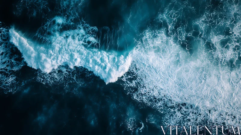 Aerial view shows foaming ocean waves in deep blue water.