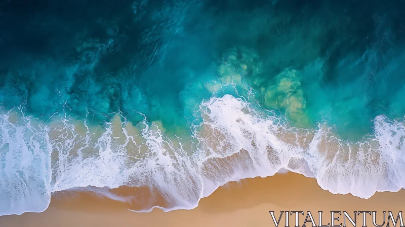 Overhead view of turquoise ocean surf on sandy shoreline.