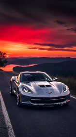 Aerodynamic silver sports coupe under saturated red sunset sky
