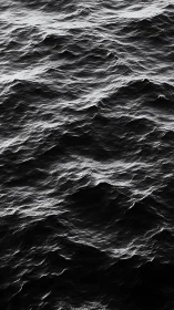 Midnight waves carve silver veins across a restless sea.