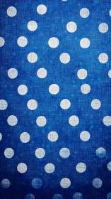 White polka dots over textured deep blue fabric field.