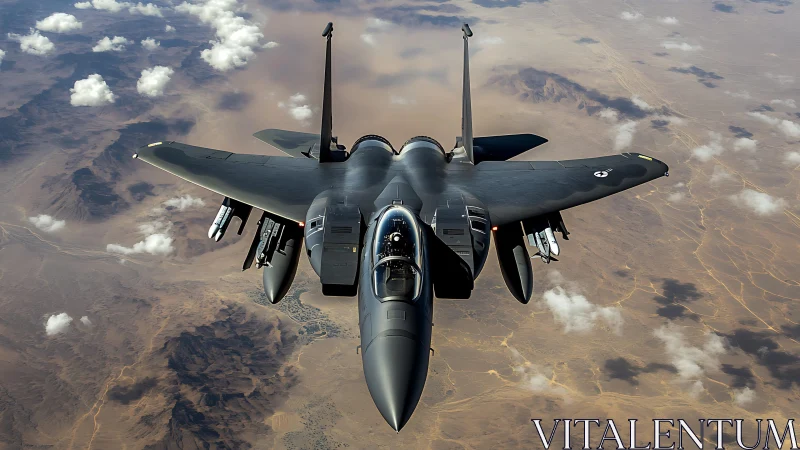 Military jet flies over arid desert terrain during daylight