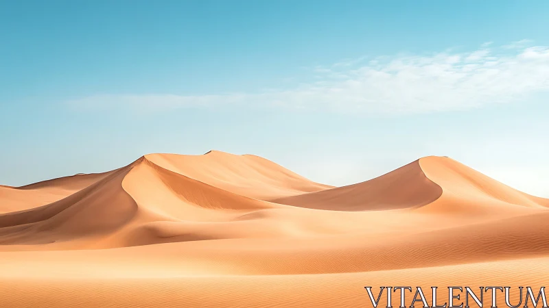 Sunlit desert dunes under clear cyan midday sky.