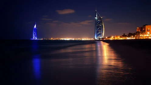Dubai luxury hotel skyline with night reflections on sea.
