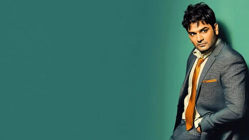 Confident man in teal suit catching a quiet spotlight moment.