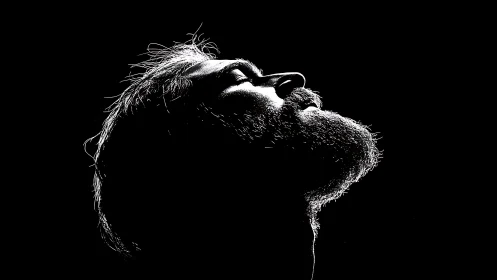 Silver-bearded silhouette drinking in a single blade of light.