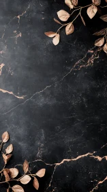 Rose gold leaves rest on dark marble crackled surface.
