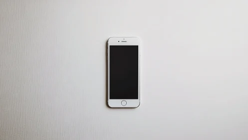 White iPhone with Black Display Screen on Neutral Surface
