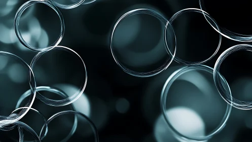 Luminous glass rings over soft teal bokeh field.