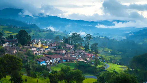 Mountain village sits in misty green valley at early morning
