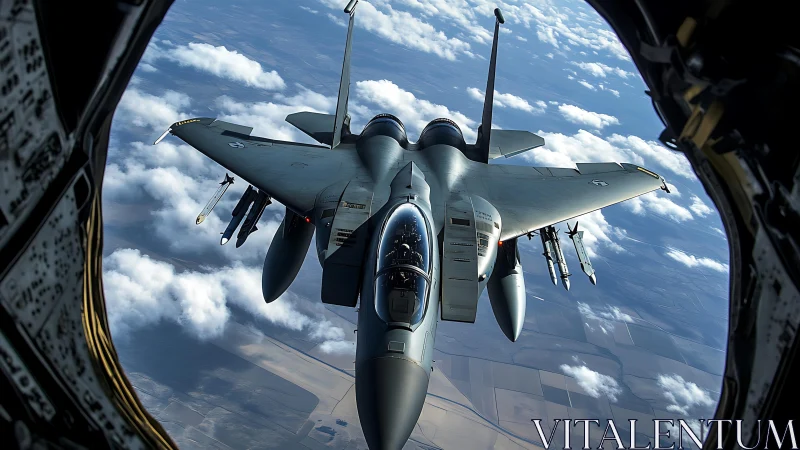 Tactical fighter jet framed from refueling aircraft viewport.