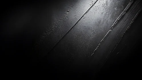 Dark textured concrete surface with diagonal light streaks.