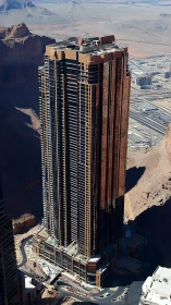 High-rise Residential Tower Aerial Perspective: Urban Vertical Architecture Above Desert Terrain