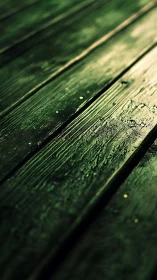 Weathered green wooden planks in diagonal closeup focus.