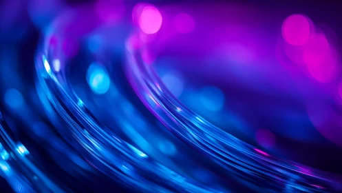 Abstract glowing fiber optic cables in vibrant blue and purple light.