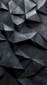 Geometric slate facets form a dark sculpted abstract surface.