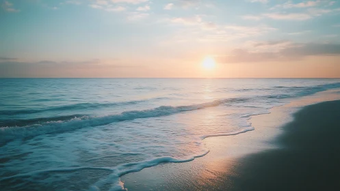 Soft sunrise tide gently brightening a quiet shoreline.