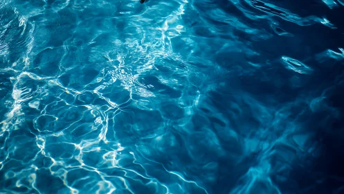 Surface ripples and light reflections move across blue water