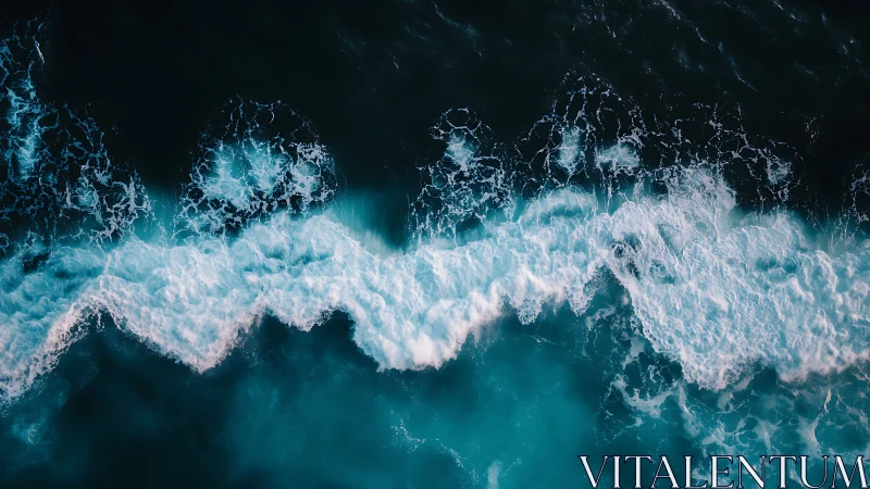 Breaking teal waves roll across a deep midnight ocean