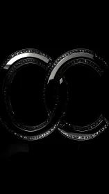 Interlocking glossy black double C emblem with crystal inlay