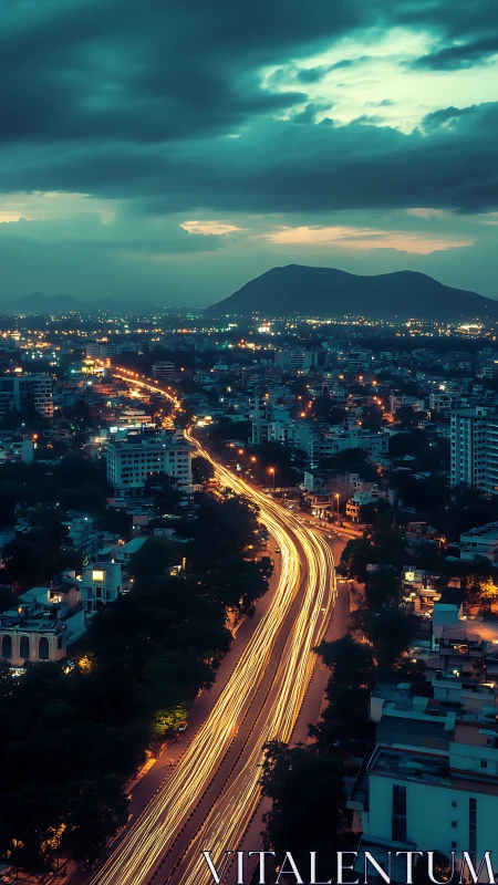 Long-exposure urban highway curves toward distant twilight mountains