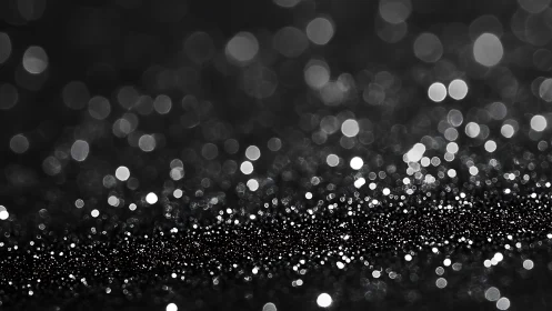 Black and white glitter bokeh with dense sparkling foreground.