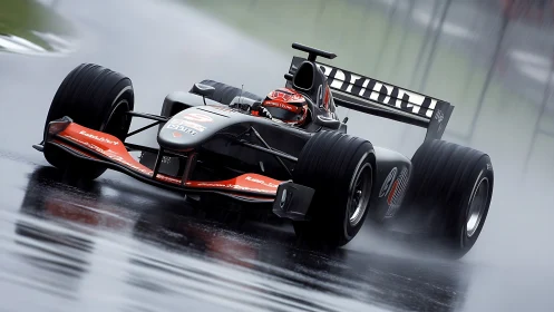 Formula race car powers through wet circuit in heavy rain.
