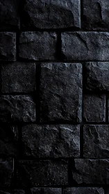 Moody black stone wall with rich texture and quiet drama.