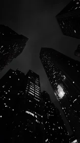 Nighttime skyscrapers framed against dark overcast sky.